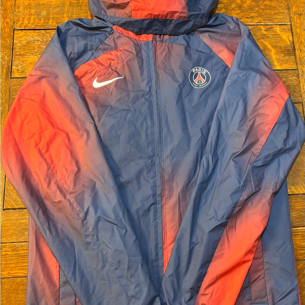 Nike PSG Paris Saint-Germain AWF Gradient Blue Rain Jacket w/ Full-Zip Closure.